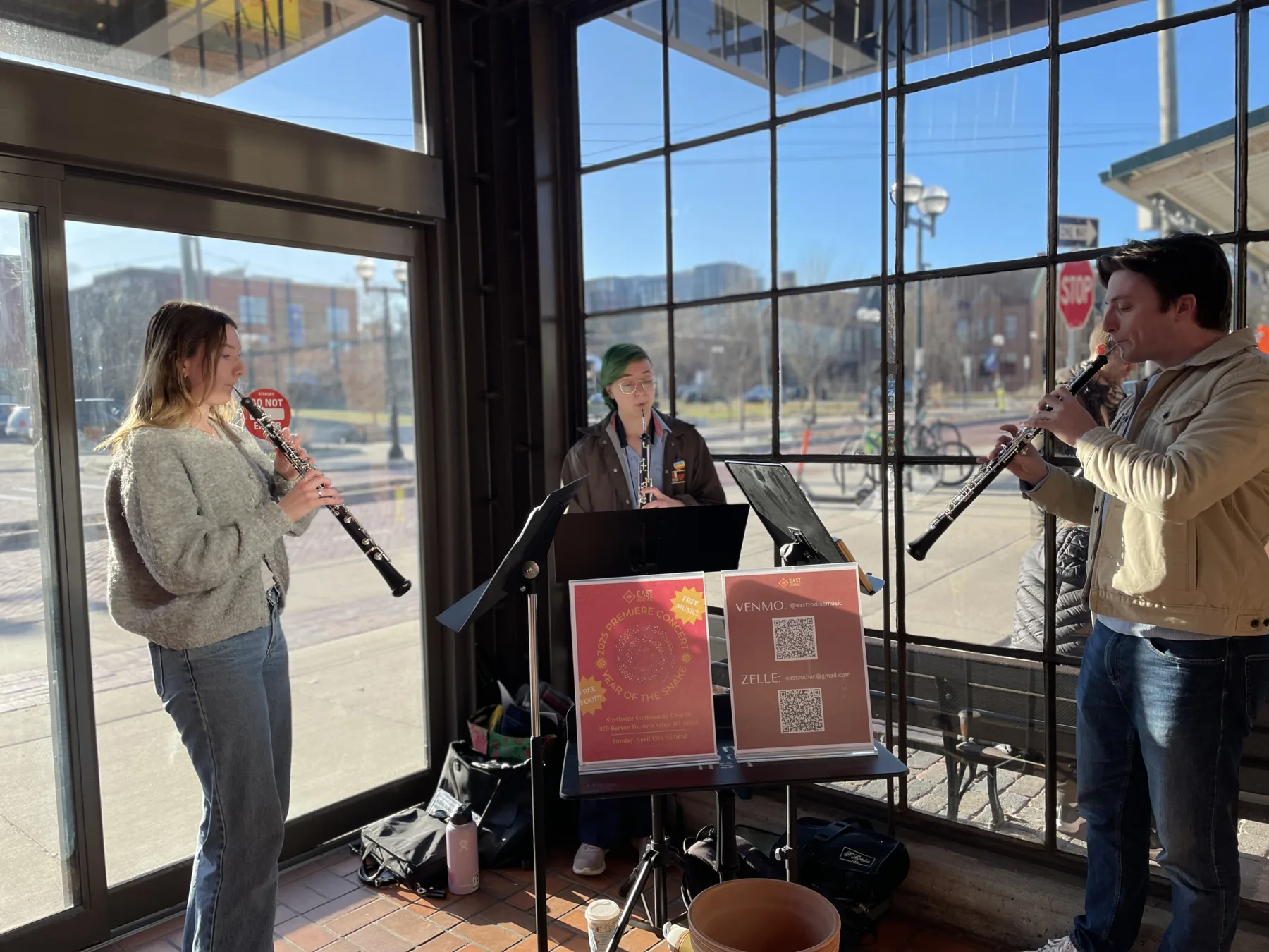 Clarinet trio performing at a local storefront in Ann Arbor